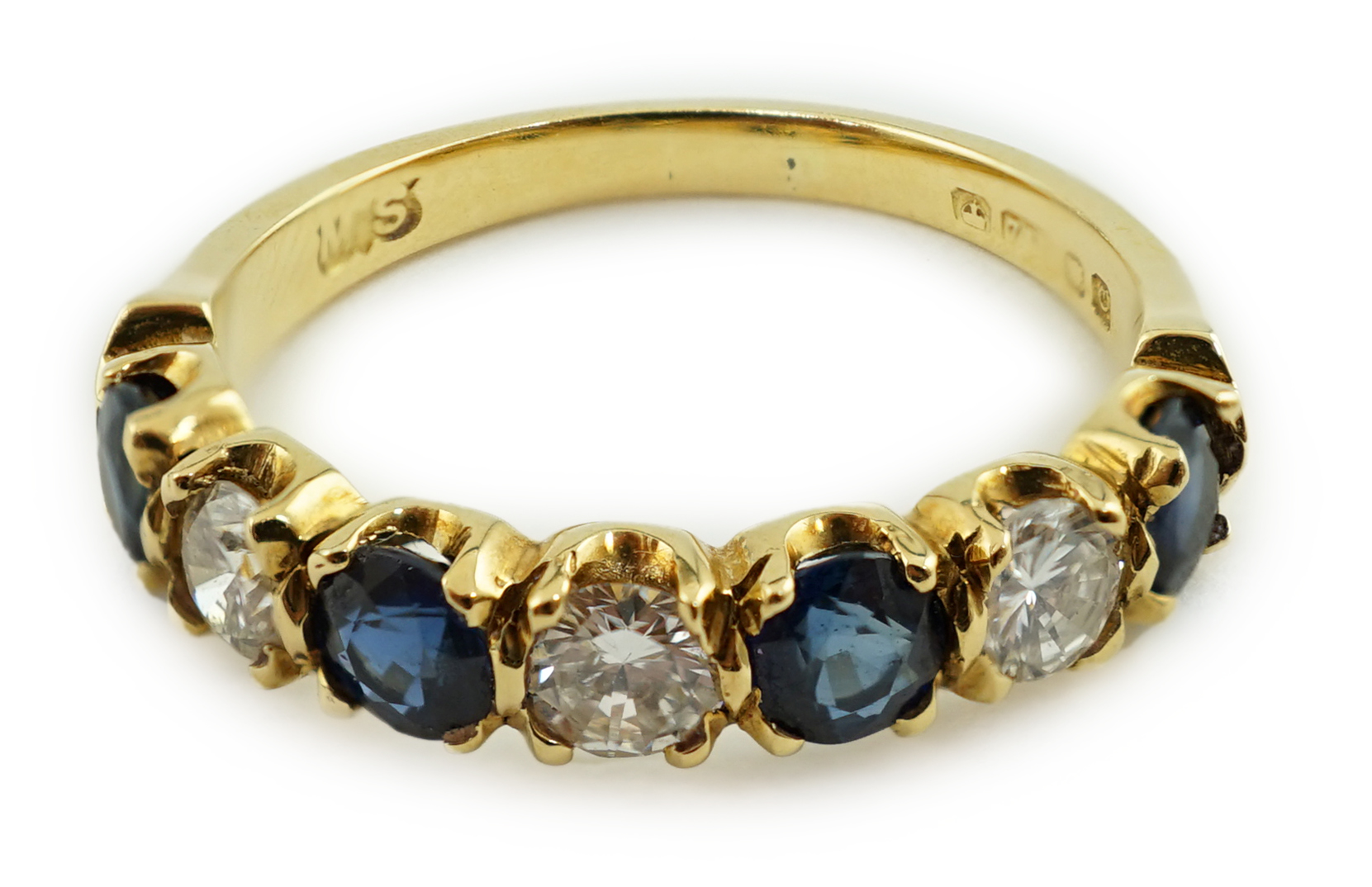 A modern 18ct gold, four stone sapphire and three stone diamond set half hoop ring